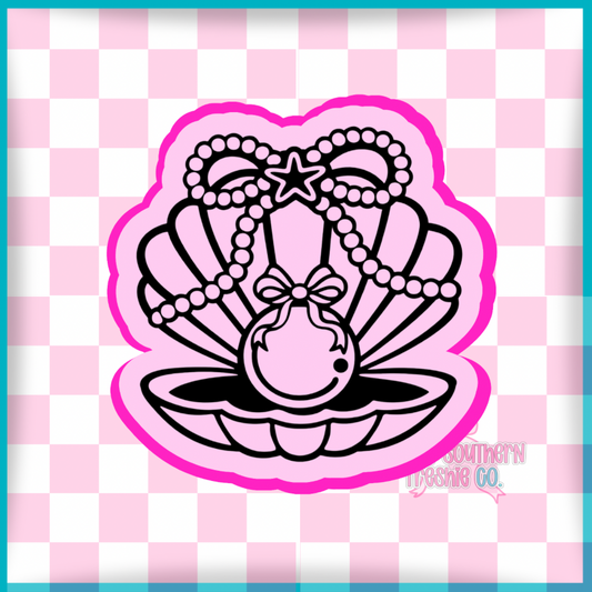 Pearl in seashell with pearl bow